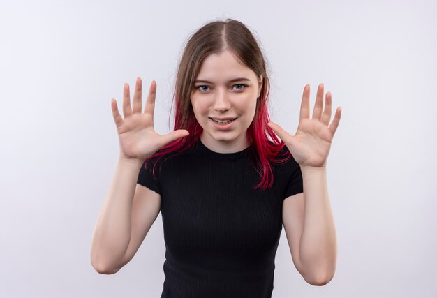 Pleased young beautiful girl wearing black t-shirt showing size on isolated white background