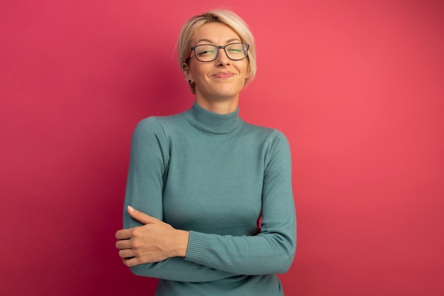 Pleased young blonde girl wearing glasses 