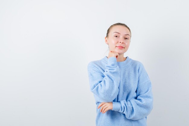 Pleasent girl is posing to camera on white background