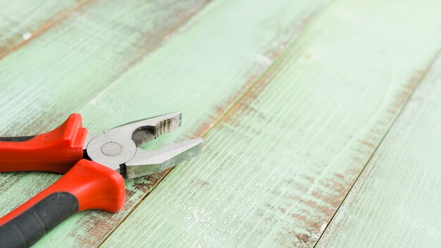 Pliers on wooden desk