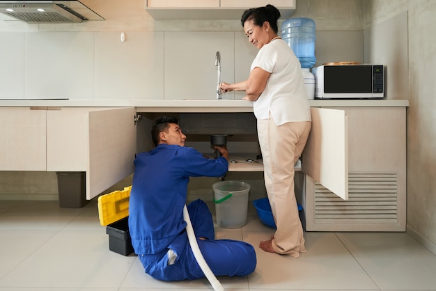 Plumber fixing pipe