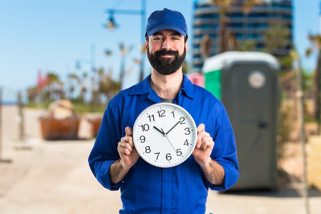 Plumber holding clock