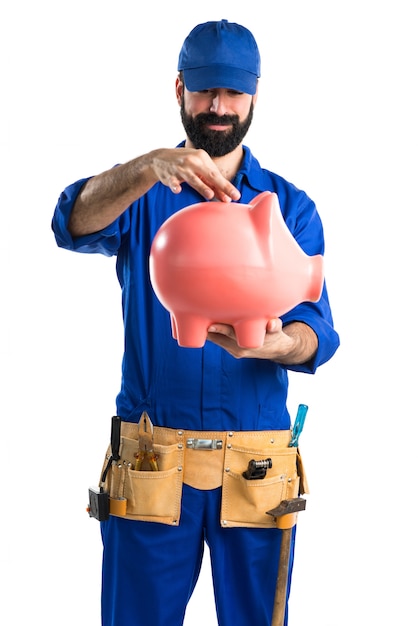 Free photo plumber holding a piggybank