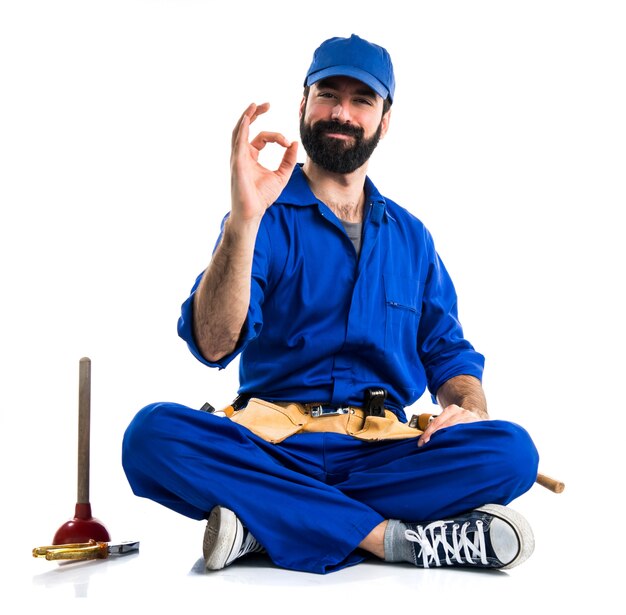 Plumber making OK sign