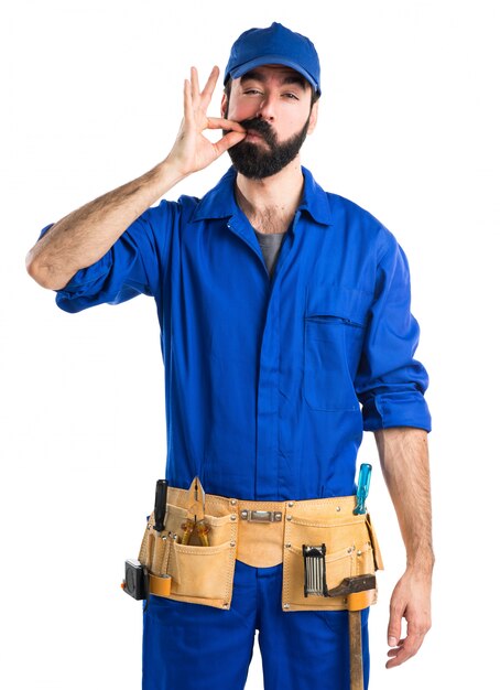 Plumber making silence gesture