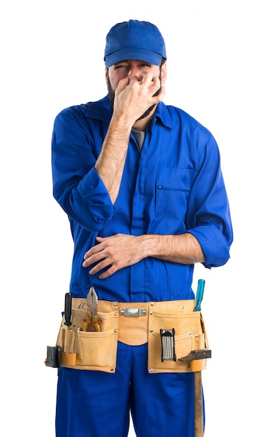 Free photo plumber making smelling bad gesture