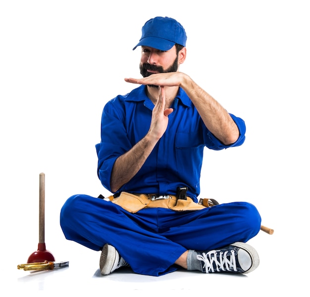 Plumber making time out gesture