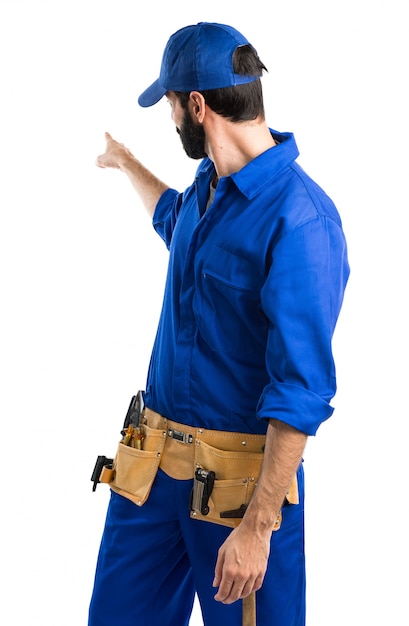 Free photo plumber pointing back