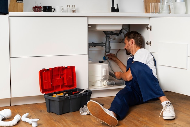 Foto gratuita professionista idraulico che fa il suo lavoro