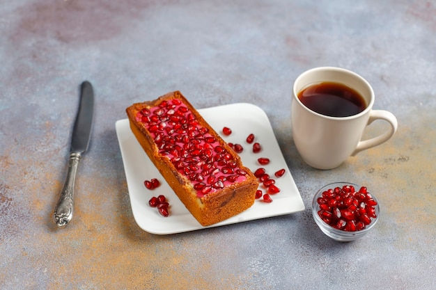 plumcake with pomegranate topping and seeds.