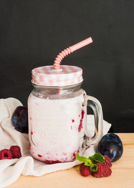 Free photo plums; raspberries smoothies against black background