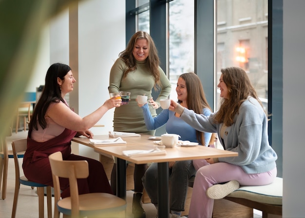Plus-size female friends spending time together at a restaurant