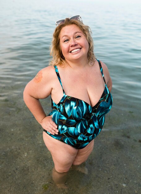 Plus size model standing in the water high view