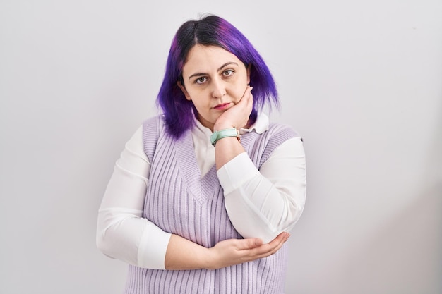 Free photo plus size woman wit purple hair standing over white background thinking looking tired and bored with depression problems with crossed arms.