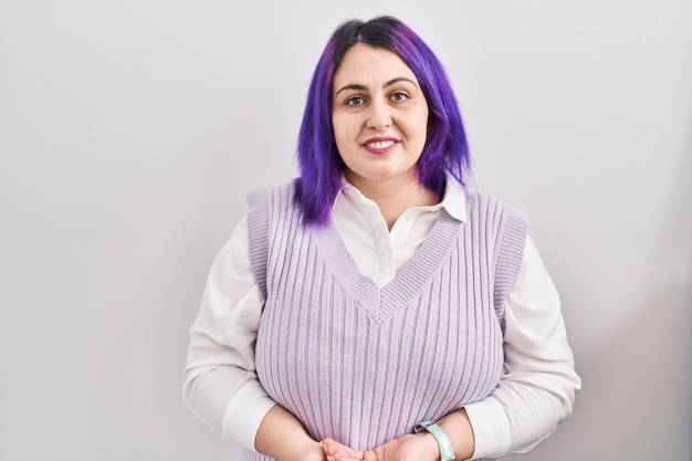 Free photo plus size woman wit purple hair standing over white background with hands together and crossed fingers smiling relaxed and cheerful success and optimistic
