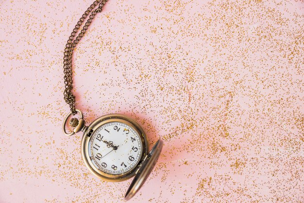 Pocket watch with sequins on table