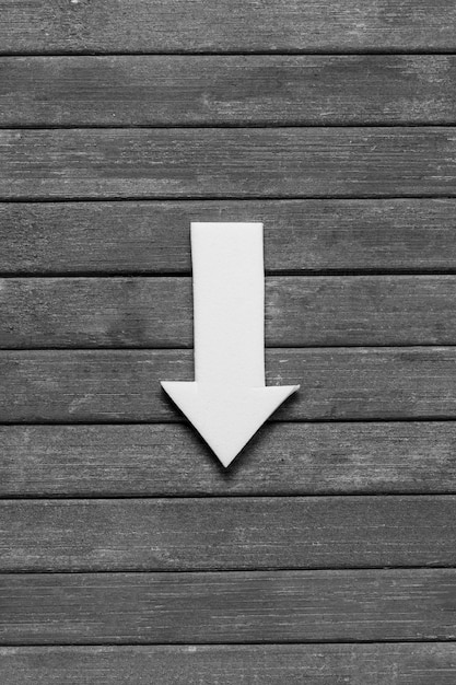 Pointy arrow on wooden background