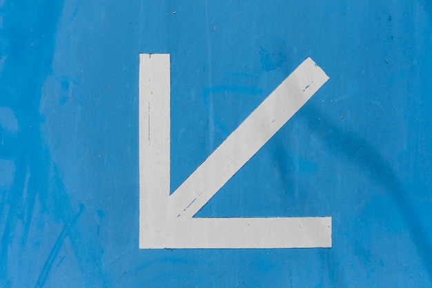 Pointy white arrow on blue background