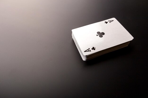 Poker chips and cards on black background