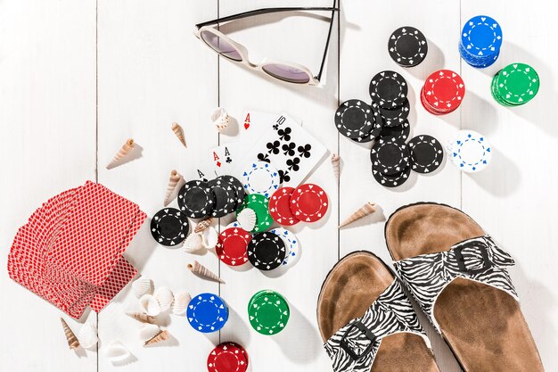 Poker. Set to playing poker with cards and chips on white wooden table, top view. Copy space