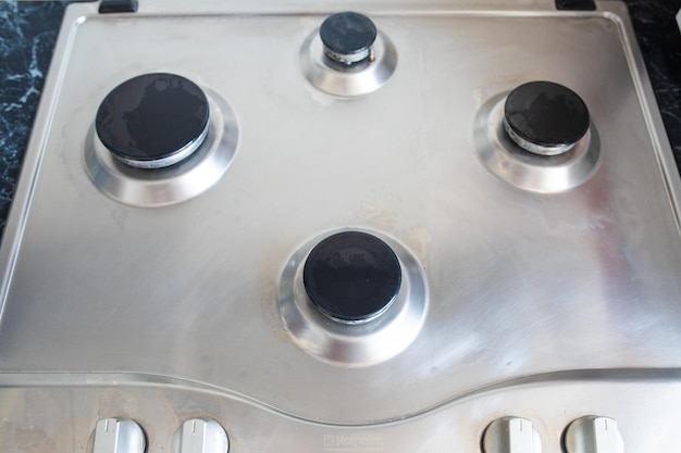 Free photo polished gas cooker after washingperfectly clean gas cooker after being washed with polishing chemicals the result of washing the burners