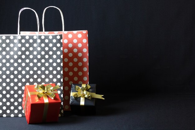 어두운 배경에 고립 된 크리스마스 선물 상자 폴카 도트 종이 봉투