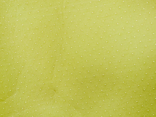 Polka dotted green textile background
