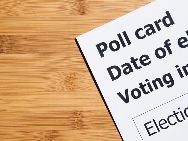 Poll card on wooden background