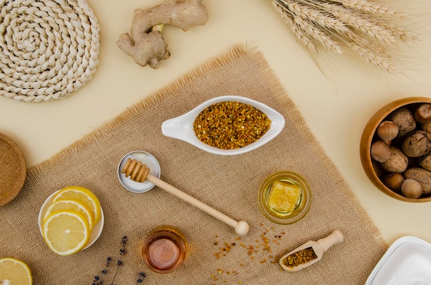 Pollen with honeycomb and honey top view with lemon