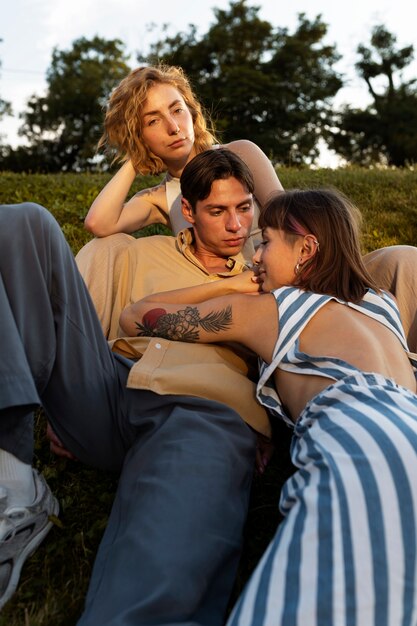 Polyamorous couple spending time together outdoors in the park