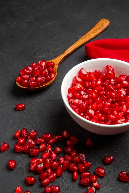 pomegranate bowl of seeds of pomegranate spoon red tablecloth