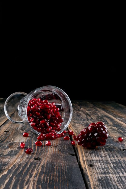 pomegranate in glass on wooden table