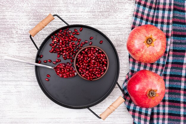 Pomegranate top view in metal black tray