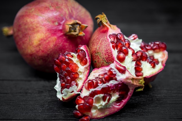 Pomegranates on a black surface