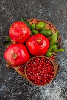 Pomegranates seeds of pomegranate and pomegranates with leaves on the board