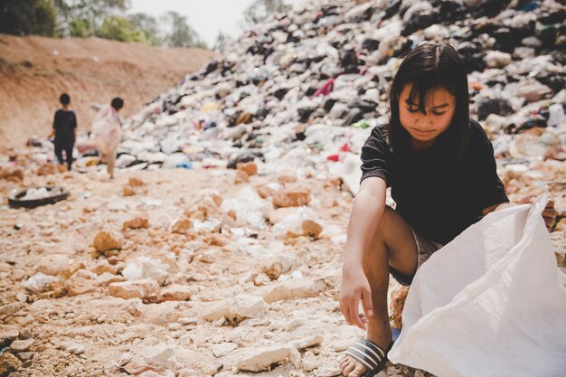 Poor children collect garbage for sale