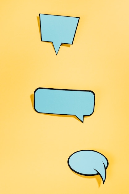 Free photo pop art style speech bubbles on yellow backdrop