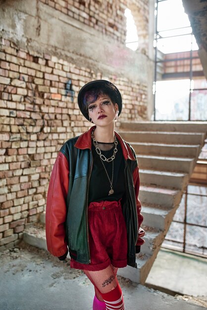 Pop punk aesthetic portrait of woman posing inside building