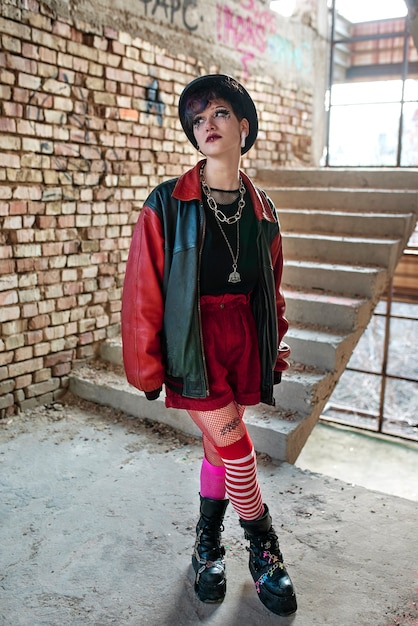 Pop punk aesthetic portrait of woman posing inside building