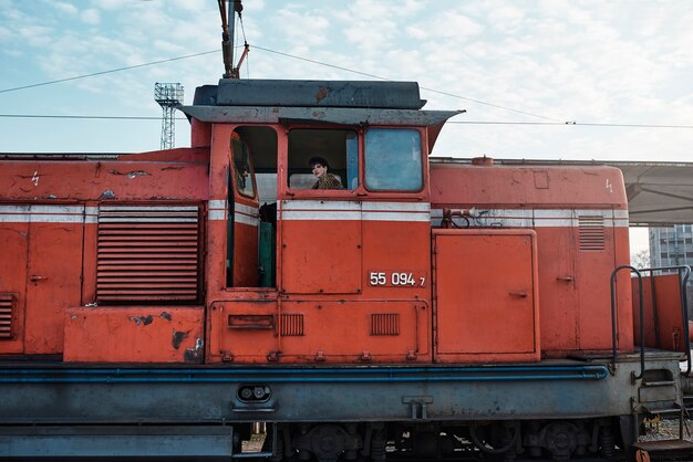 Pop punk aesthetic portrait of woman posing in locomotive