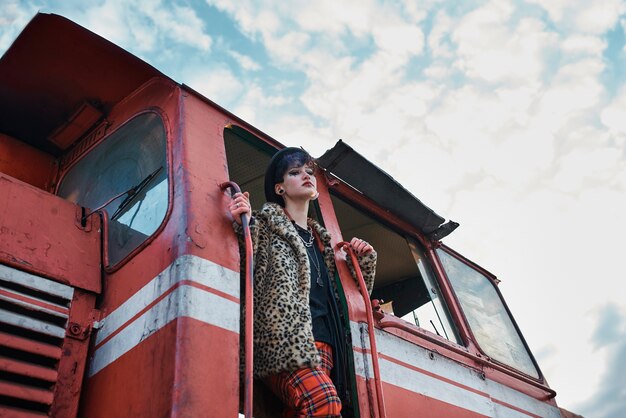 Pop punk aesthetic portrait of woman posing in locomotive