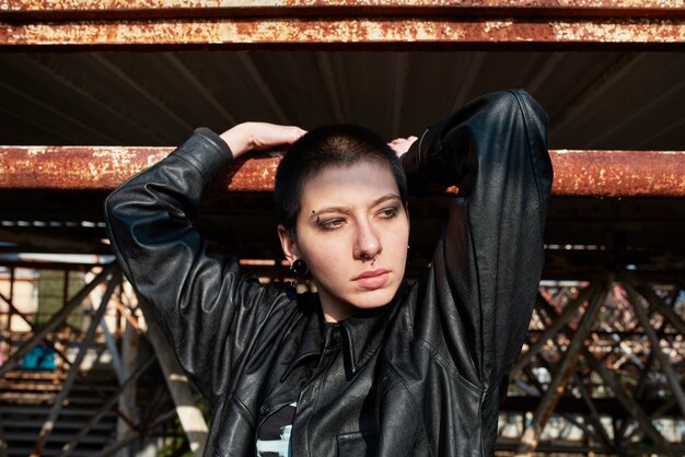 Pop punk aesthetic portrait of woman posing on metal structure