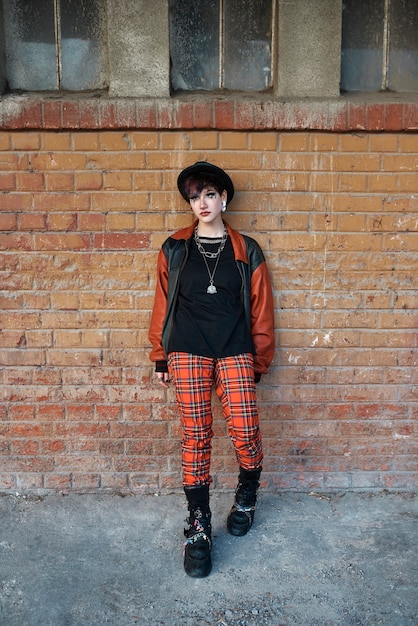 Pop punk aesthetic portrait of woman posing in train station