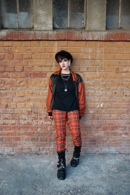 Pop punk aesthetic portrait of woman posing in train station