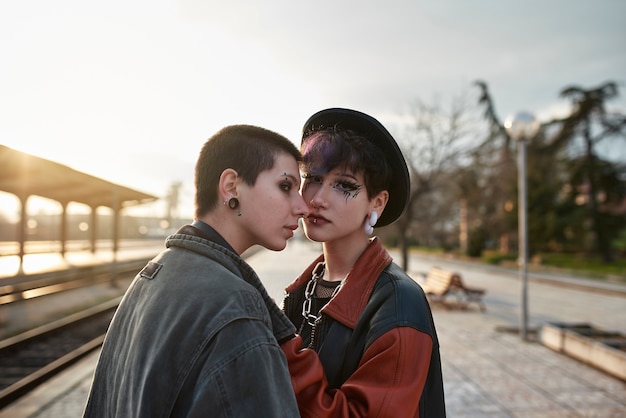 Pop punk aesthetic portrait of women posing in train station