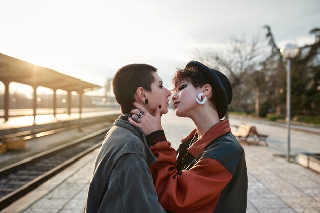 Pop punk aesthetic portrait of women posing in train station