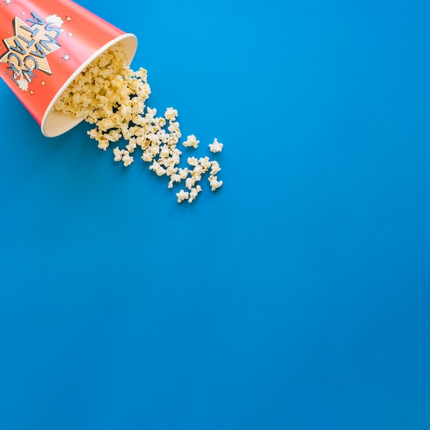 Popcorn on blue background with space on right