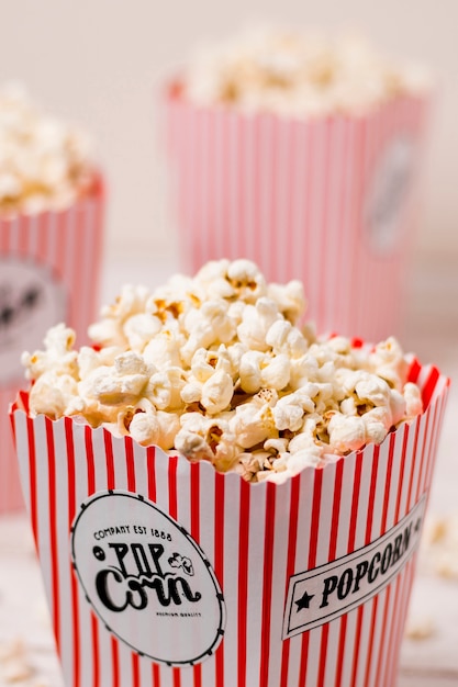 Free photo popcorn box filled with salty fluffy popcorns