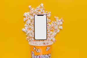 Foto gratuita scatola di popcorn con il telefono cellulare