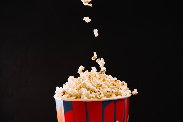 Popcorn falling into bucket